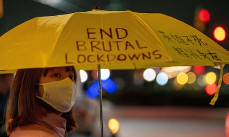 A person holding an umbrella takes part in anti-Chinese government protests near the Chinese consulate in New York.