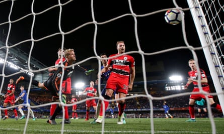 The Huddersfield players hold their breath as Jonas Lössl’s fingertip save comes back off the post to deny Chelsea a winner after a wild goalmouth scramble.