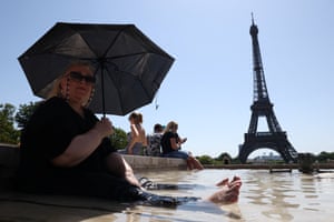 Paris, FranceA tourist cools off in the Trocadero Fountain next to the Eiffel Tower