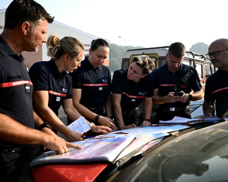 Firefighters check the maps during a briefing in the evacuated town of Lege-Cap-Ferret, west of Bordeaux.