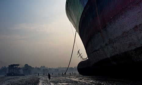 A huge freighter towers over a beach in Chittagong, where it will be disassembled and its parts recycled