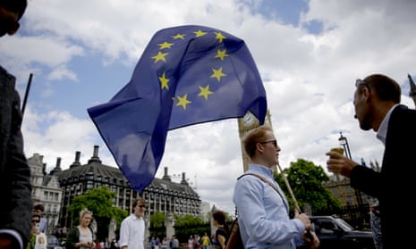 A remain supporter carries an EU flag outside parliament in London. 