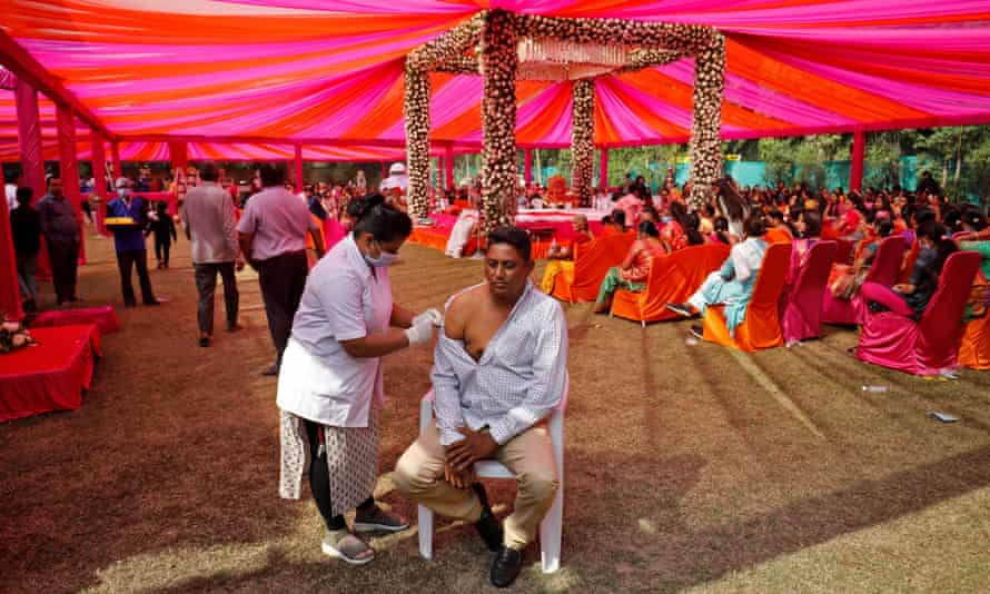 A wedding guest receives a dose of Covid vaccine during a quiet moment.