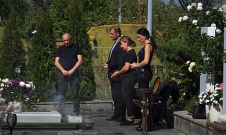 A family mourn at a graveside
