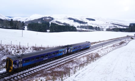 A train travels through a snowy landscape