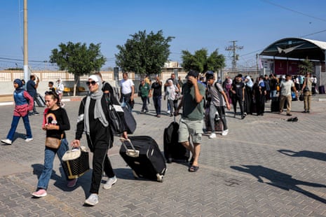 People enter the Rafah border crossing in the southern Gaza Strip before crossing into Egypt