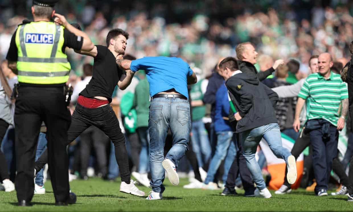 Fans clash on the Hampden Park pitch.