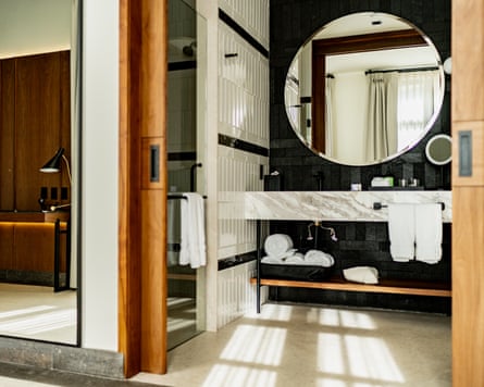 A hotel bathroom with a sliding door