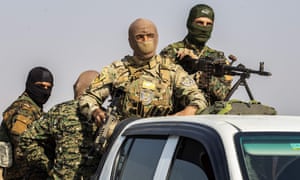 Fighters from the Syrian Democratic Forces as they withdraw from the Sanjak Saadoun border area near the northern Syrian town of Amuda, on 27 October.