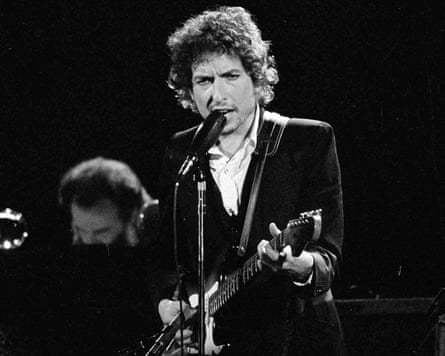 Bob Dylan on stage with guitar