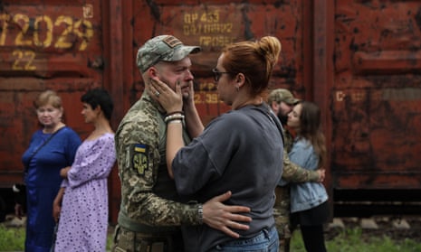 A couple bid each other farewell at the railway station in Kramatorsk, Donetsk region.