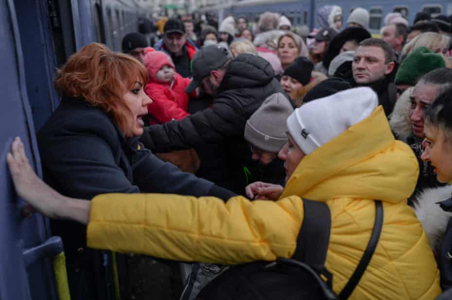 Crowds of people try to board train