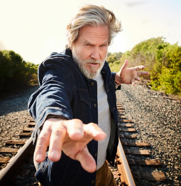 Jess Bridges standing on a railway line, one arm forward as if casting a spell