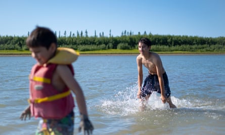 Brothers Rocky Gordon, left, and William cool off in the Mackenzie River during a heatwave.