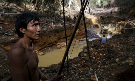 A Yanomami stands near an illegal gold mine during Brazil’s environmental agency operation against illegal gold mining on Indigenous land.