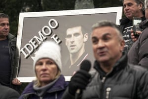 Serbian tennis player Novak Djokovic’s father Srdjan Djokovic (R) speaks flanked by his wife Dijana Djokovic (L), as they take part in a rally in front of Serbia’s National Assembly, in Belgrade, on January 9, 2022.