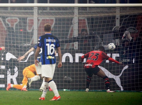 AC Milan’s English defender Fikayo Tomori diverts the ball into the net.