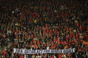 A banner asking Qatar to act on human rights abuses is held by supporters at a World Cup qualifier game between Belgium and Estonia on 13 November