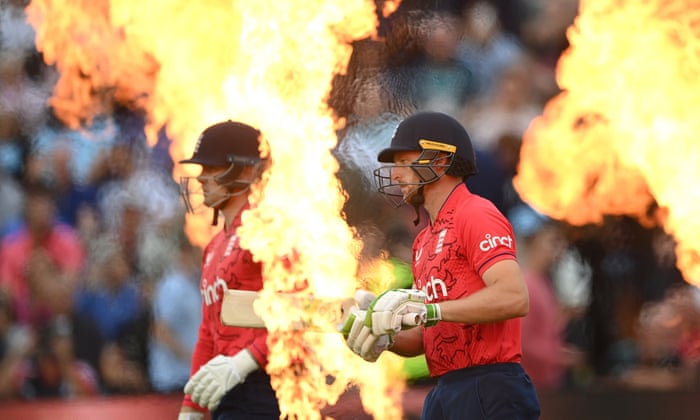 England batters Jos Buttler (right) and Jason Roy come out through the flames to bat.