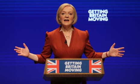 liz truss at conference speech lecturn with sign saying getting britain moving
