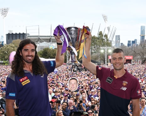 Fremantle captain Alex Pearce and Brisbane co-captain Josh Dunkley hold the AFL premiership cup
