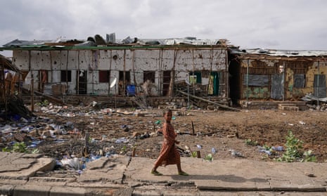 A child walks in front of severely damaged buildings  destroyed during the TPLF occupation and liberation of Chifra.
