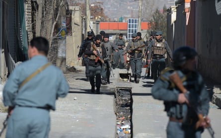 Police officers keep watch after the explosions in Kabul.
