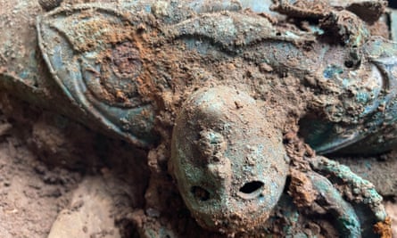 Close-up of a mask-like human face in metal