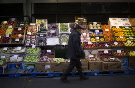 A customer walks past a display of produce at the Hunts Point Terminal Produce Market in the Bronx borough of New York, U.S.
