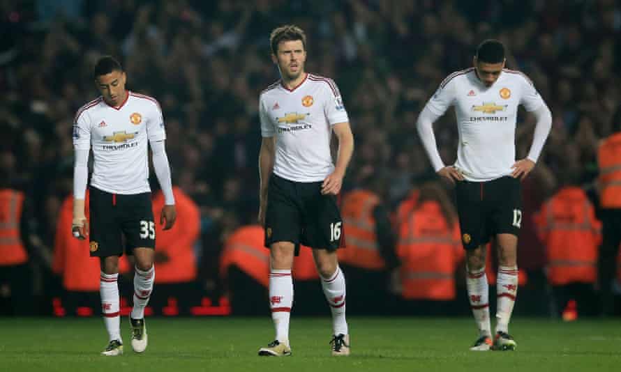 Jesse Lingard, Michael Carrick and Chris Smalling walk off the pitch dejected after defeat.