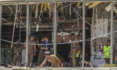 Sri Lankan police officers inspect the site of explosion at the Shangri-La hotel in Colombo in April 2019.