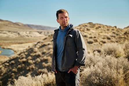 A man posing for a picture with his hands in his pockets.