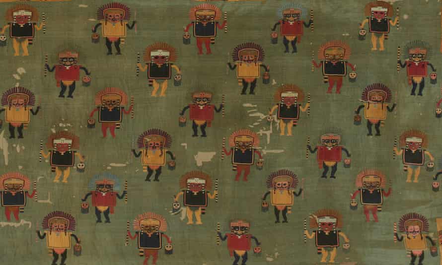 Mantle depicting human figures with feline mouth masks holding severed heads from Peru: A Journey in Time.