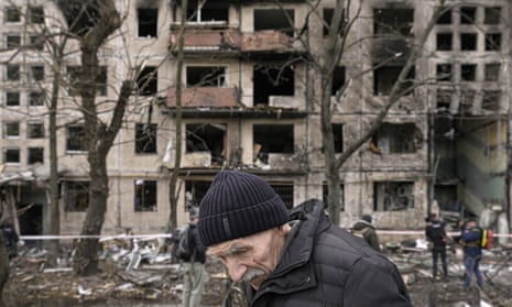 An elderly man outside an apartment block damaged by an artillery strike in Kyiv, Ukraine, 14 March 2022.