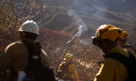 Firefighters from Mexico cut a containment line