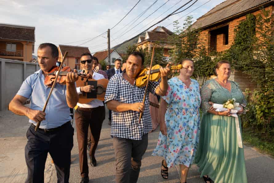 Violinists play Pop-Hotcas during Jesica Monica Bura's and Grigore's wedding procession