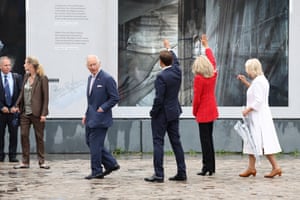 Charles looks back as the Macrons wave, with Camilla following behind