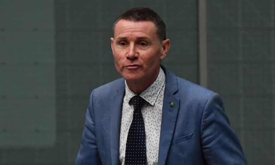 white man with short hair in a blue suit and tie