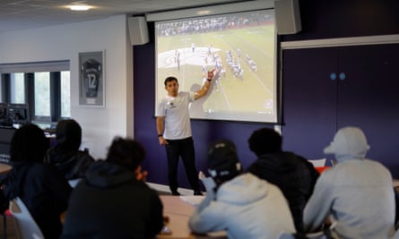 Daniel Docal, the defensive coordintor originally from Madrid, goes through a film showing De la Salle Spartans attacking formations with his players after a training session for the NFL Academy at Loughborough University.