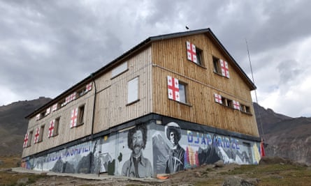 Altihut exterior with murals of famous Georgian mountaineers.