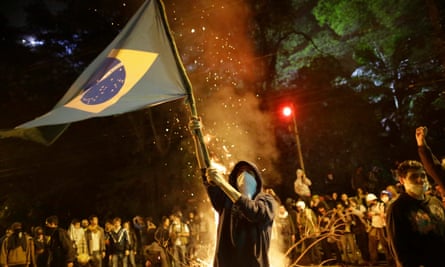 A demonstrator waves a Brazilian flag during a protest in São Paulo, Brazil, June 2013.