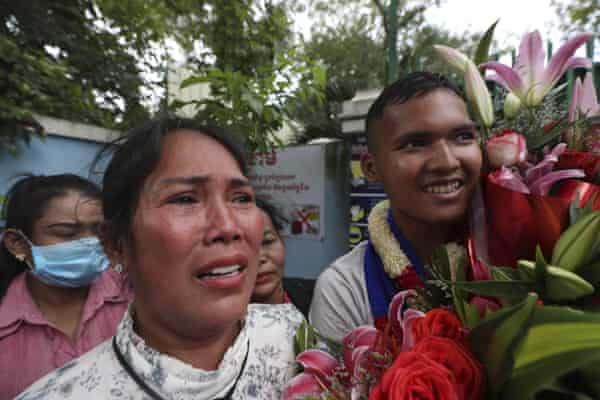 Prum Chantha, front left, stands with her son Kak Sovannchhay, 16, outside the main prison of Prey Sar on the outskirts of Phnom Penh, Cambodia, 10 November 2021