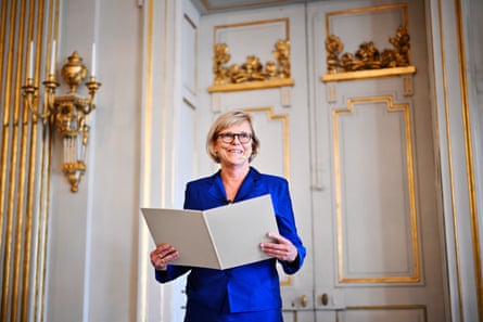 Ingrid Carlberg smiling while announcing the winner in an ornate room