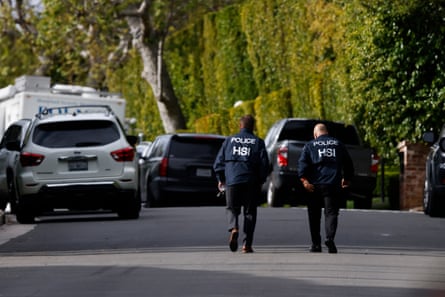 Federal investigators walk on a closed off road outside of a home owned by Sean ‘Diddy’ Combs in Los Angeles, California.