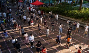 People queue up at a temporary polling station to vote for pro-democracy candidates during unofficial primary elections in Hong Kong on 12 July 2020.