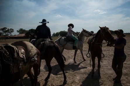 Indigenous Enxet and Ayoreo workers on horses at a huge estate in the Chaco