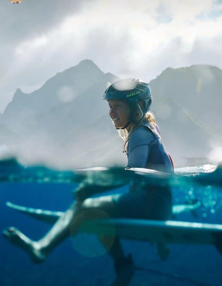 Kelia Mehani Gallina sits on a surfboard