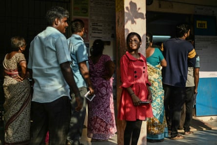 A girl waits for her parents to cast their ballots at a polling station during the first phase of voting of India’s general election in Chennai
