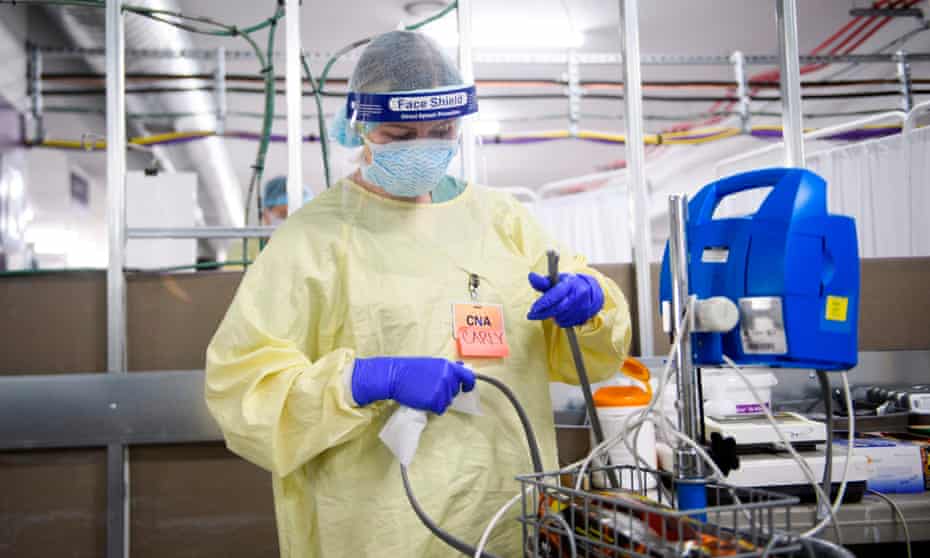 A certified nursing assistant sanitizes a patient vitals monitor in Reno, Nevada, on 16 December 2020. 