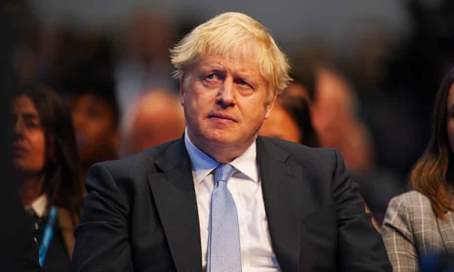 Boris Johnson listening to Rishi Sunak's speech to the Conservative party conference in Manchester earlier this month.
